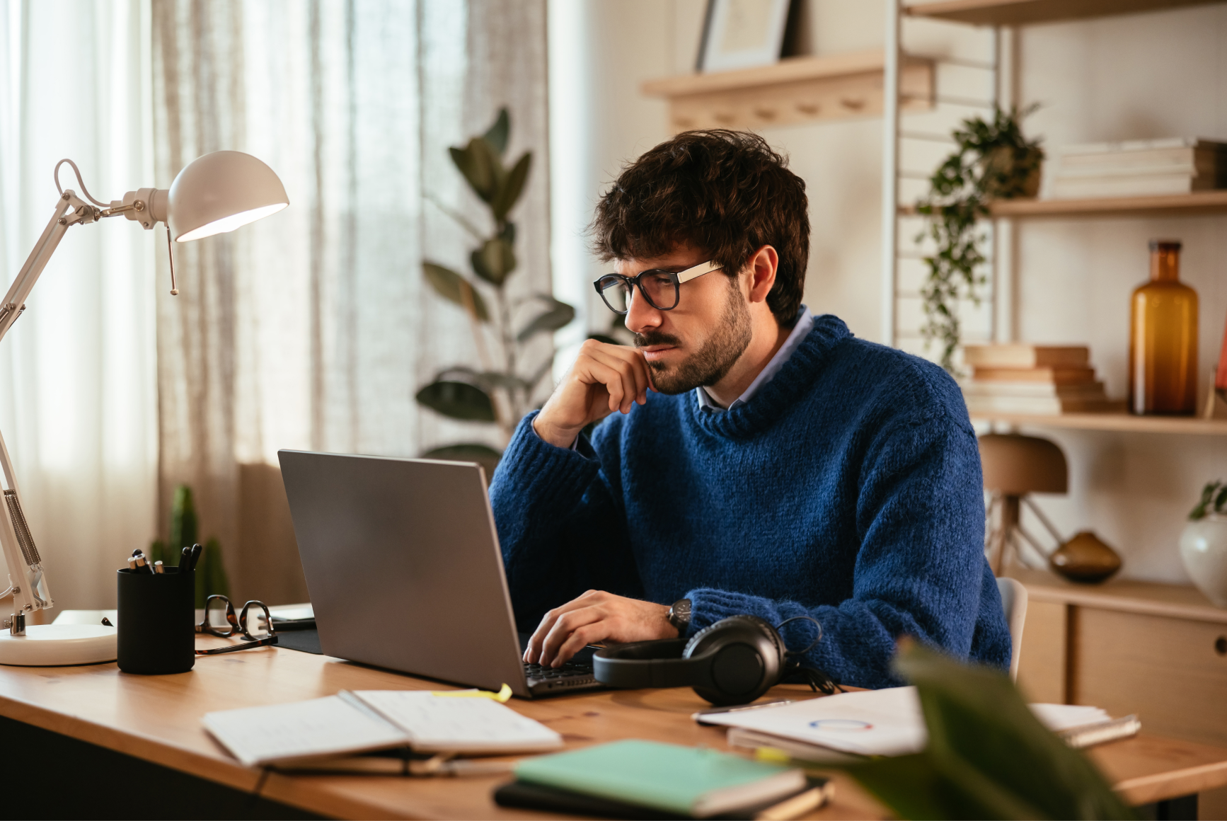 A tax client reviewing documents on his laptop