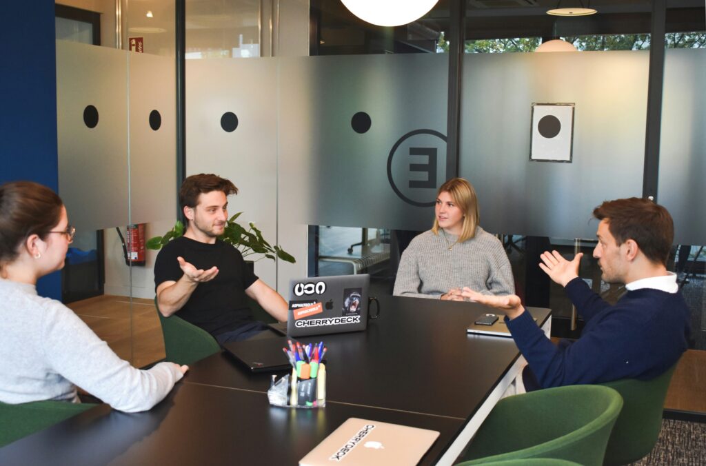 A business meeting a warm, sunlit room.