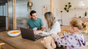 young parents calculating and managing family budget while sitting at table with laptop at home
