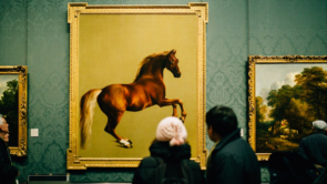 People observing fine art in a gallery