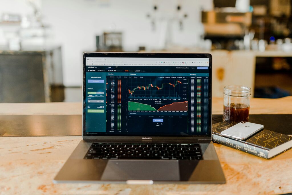 An open MacBook Pro on a desk, symbolizing research and financial planning.