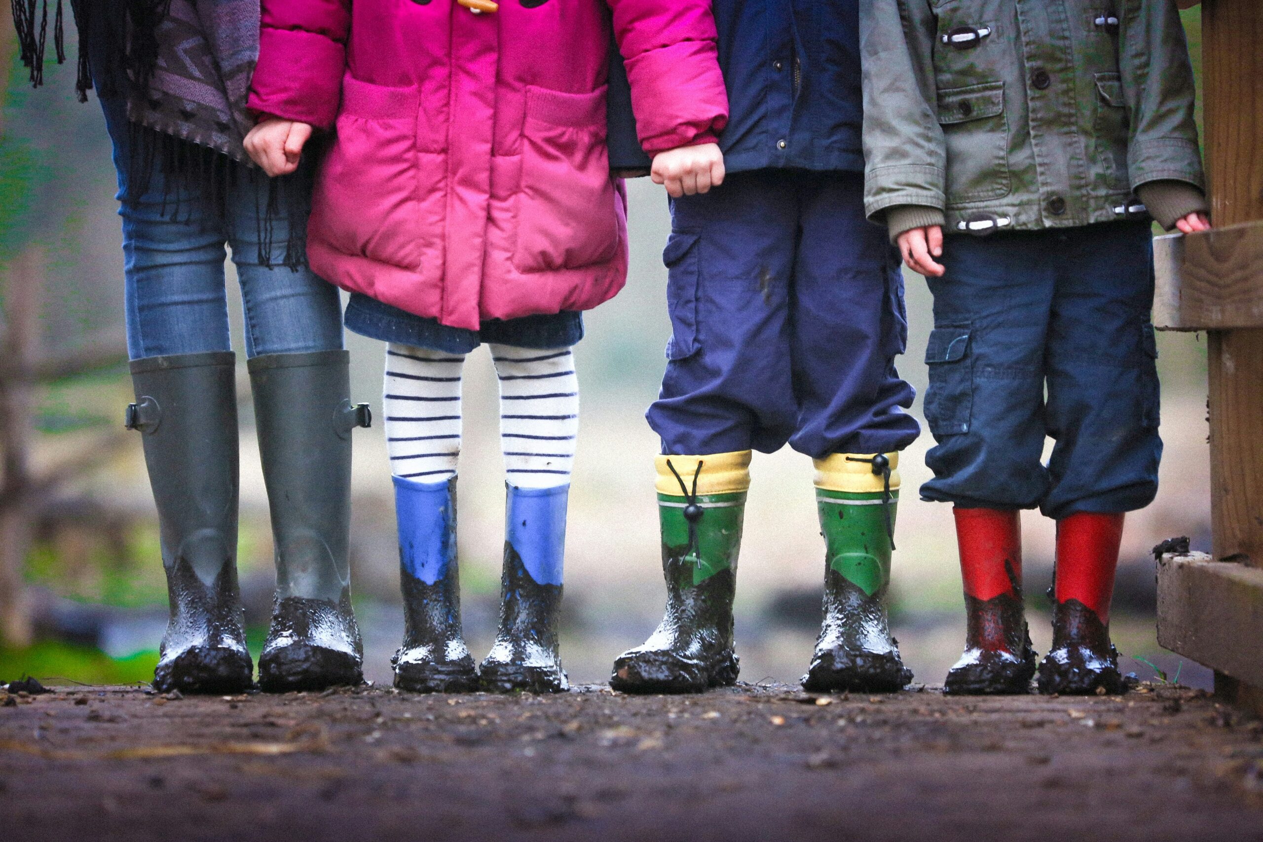 Four children stand together outdoors in a rural setting, symbolizing the families and dependents at the heart of the Child Tax Credit.