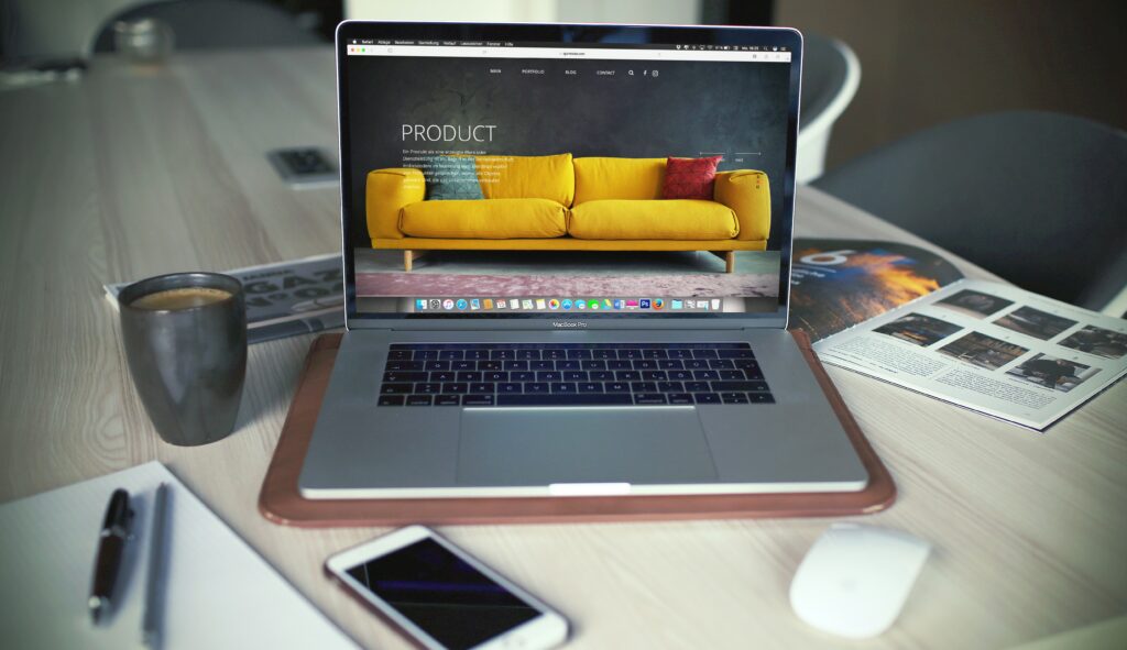 A turned-on MacBook Pro next to a gray mug, symbolizing the digital economy and the complexities of multistate tax issues.