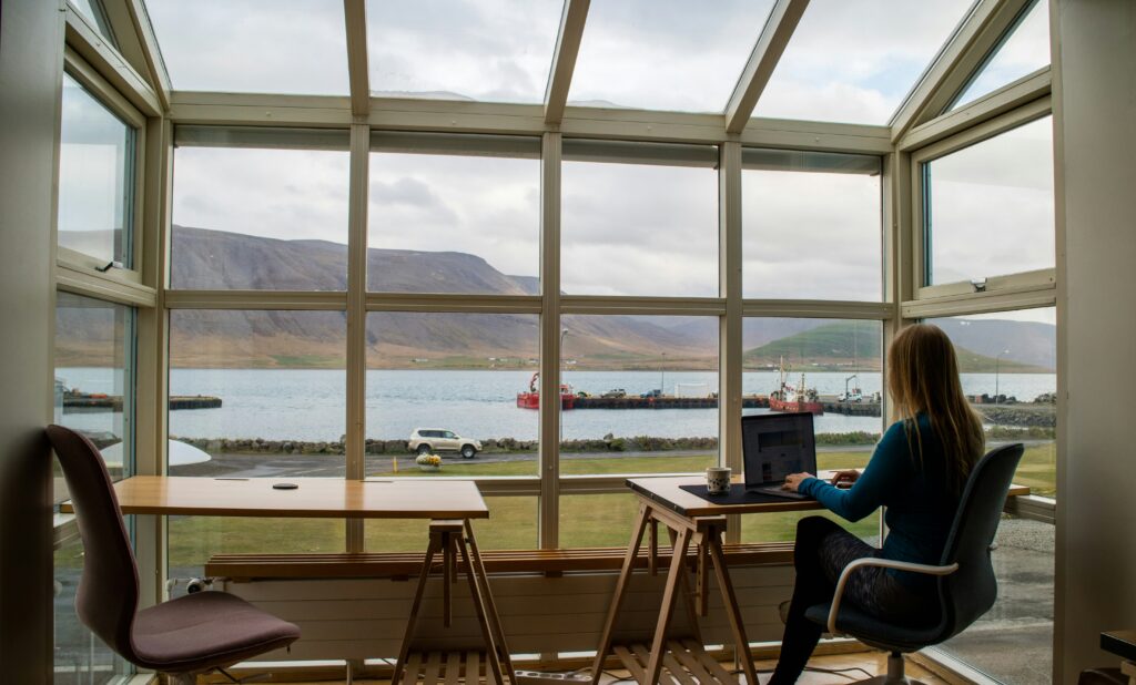 A person in a blue jacket sitting on a brown wooden chair at a wooden table, reflecting the importance of strategic planning in navigating multistate tax issues for clients.