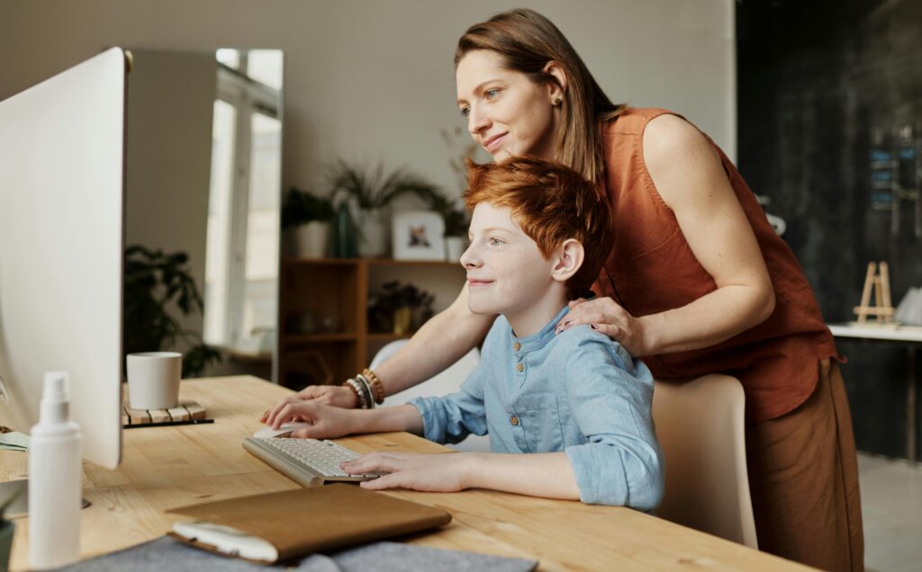 A mother teaches her child at home—representing the expanded 529 planning opportunities under the OBBB, including new coverage for K-12 and homeschooling expenses.