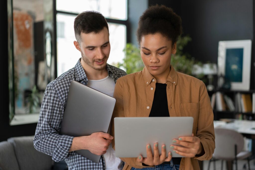 A client and advisor review information on a laptop—illustrating how automation platforms streamline the engagement letter process and reduce onboarding delays.