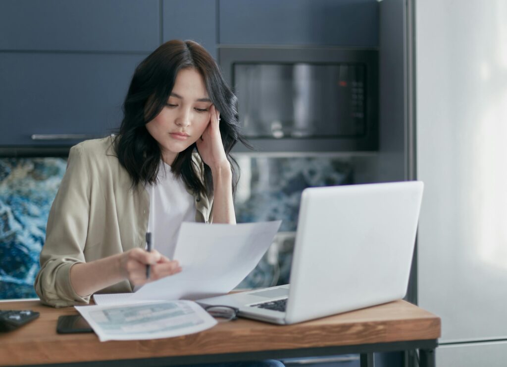 A professional team discusses invoices on a laptop—depicting the manual billing challenges many tax advisors face.