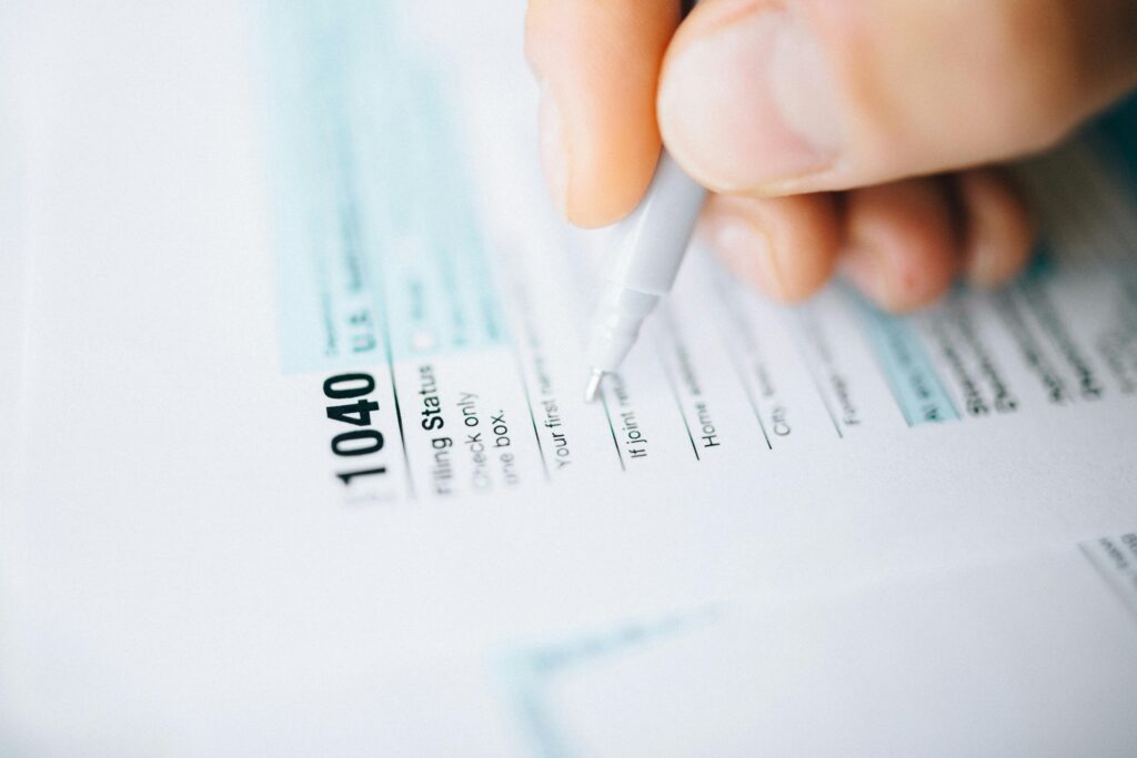 Image of a person filling out tax documents.