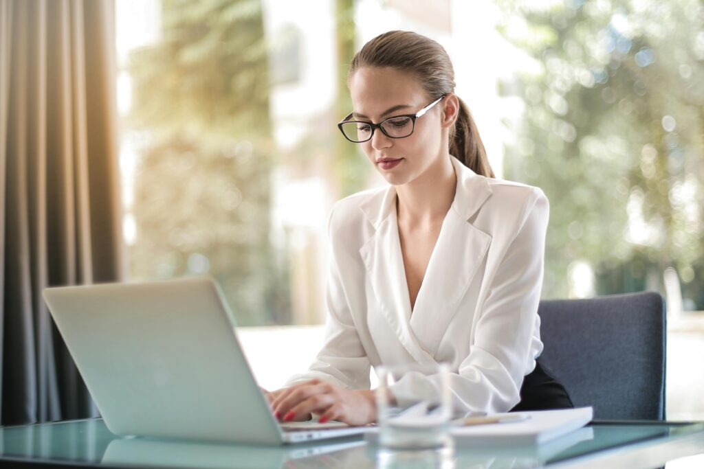 A focused professional works on a laptop—symbolizing how tax advisors use platforms like Harness to automate engagement letters and improve client onboarding workflows.