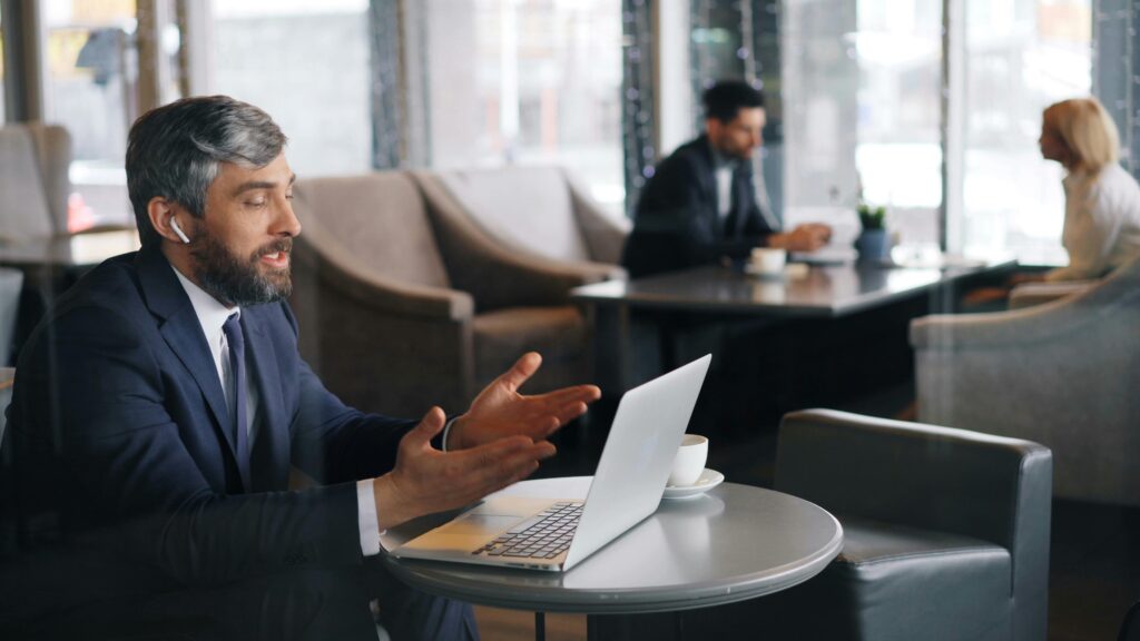 A professional in a suit works remotely from a laptop—symbolizing the flexibility and efficiency enabled by digital back office tools in tax practices.