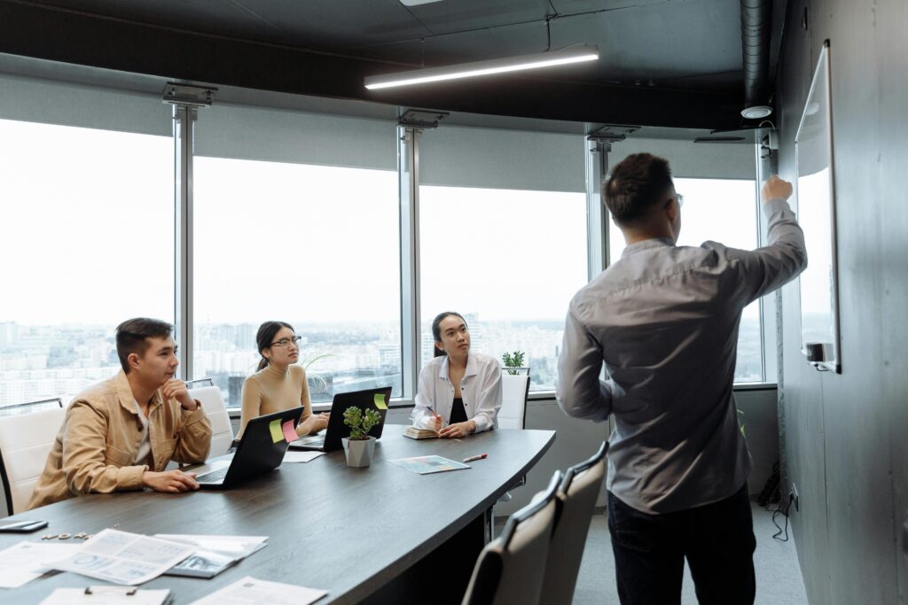 A professional presents workflow strategies during a team meeting—symbolizing the value of standardized processes and technology adoption in modern tax practices.