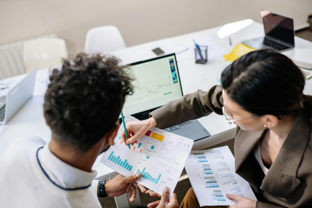 Two colleagues review performance dashboards—symbolizing the improved efficiency and financial insight that automated billing software provides for tax firms.