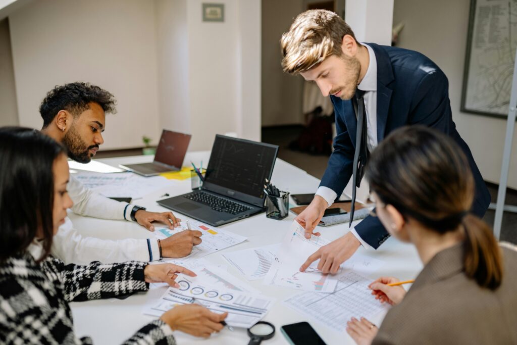 A group of professionals reviews documents together—illustrating how back-office automation and client portals can improve efficiency in tax firm workflows.
