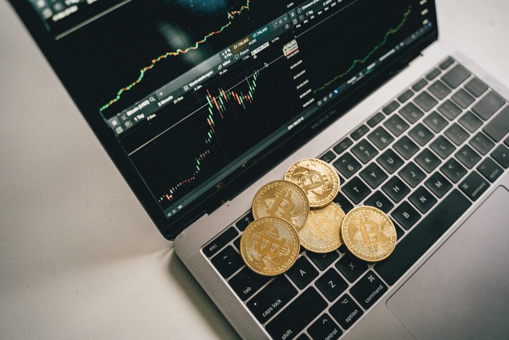 Gold coins scattered across a laptop keyboard—symbolizing the intersection of cryptocurrency and digital finance, and the growing importance of tax-smart strategies like crypto loss harvesting.