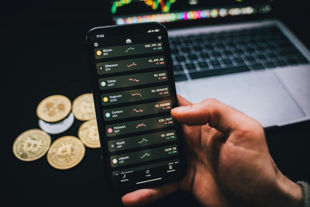 A person viewing cryptocurrency trading charts on a smartphone—illustrating how investors track performance and identify potential tax loss harvesting opportunities in a volatile digital asset market.
