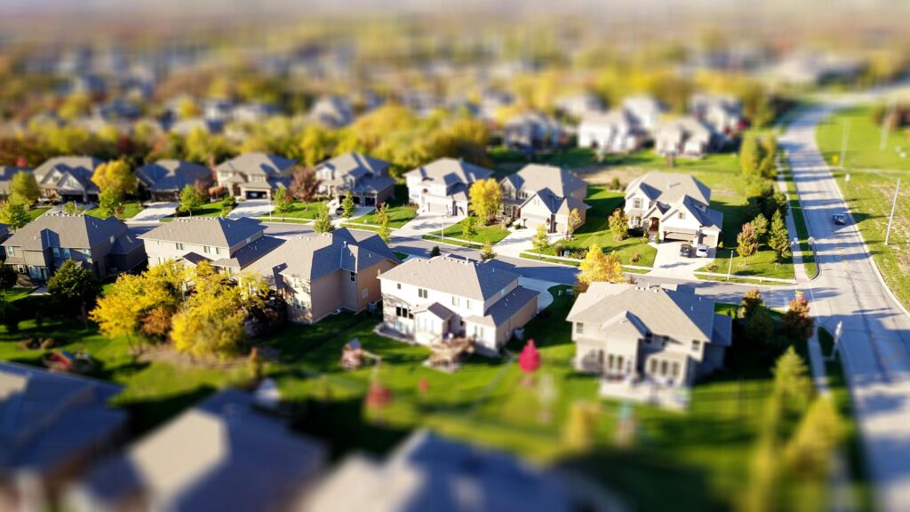 Aerial view of a suburban neighborhood—highlighting the geographic differences in property tax laws that real estate investors must navigate when managing multi-state portfolios.
