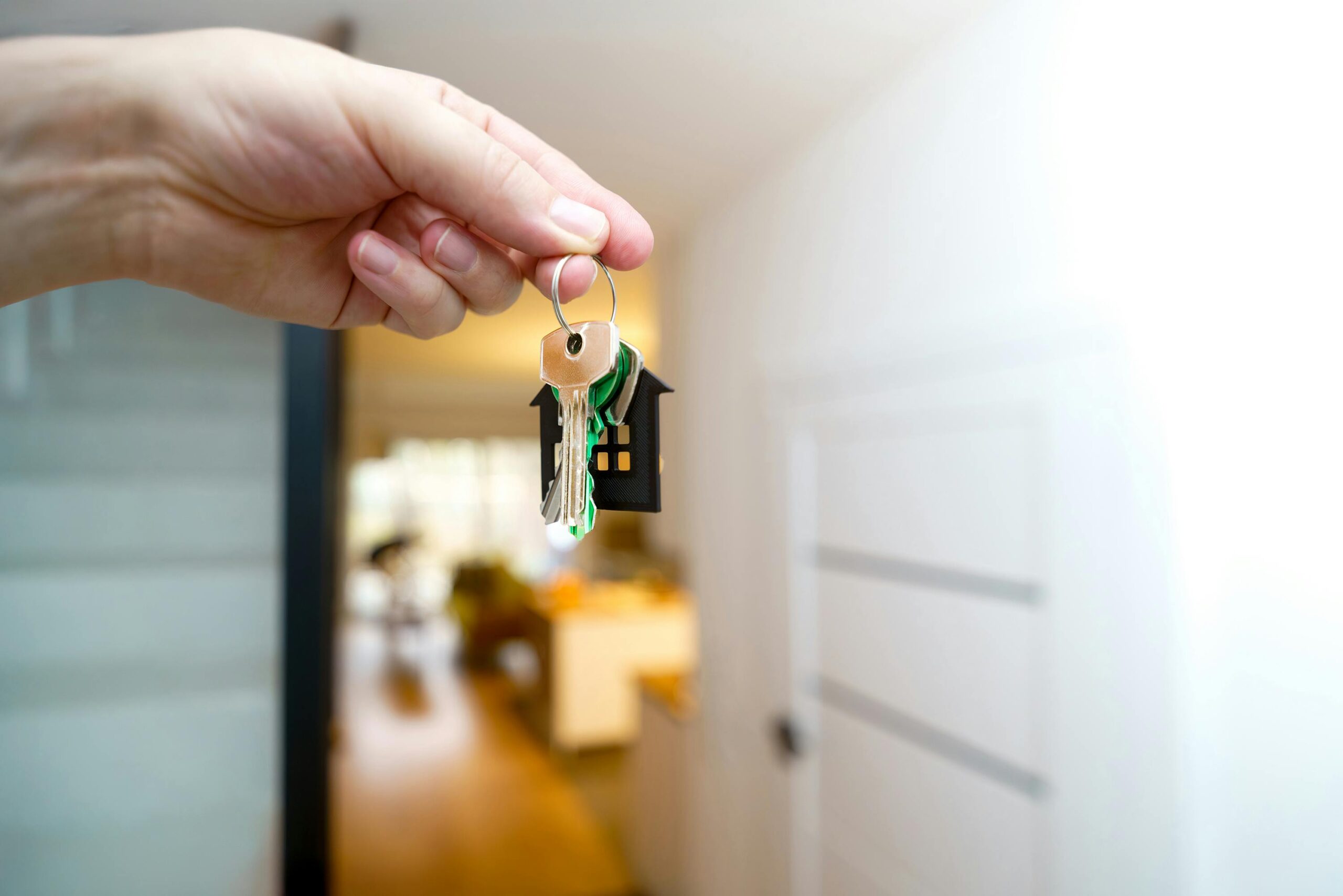 A real estate agent holding keys to a new property—symbolizing property ownership and the tax planning strategies needed to maximize real estate investment returns.