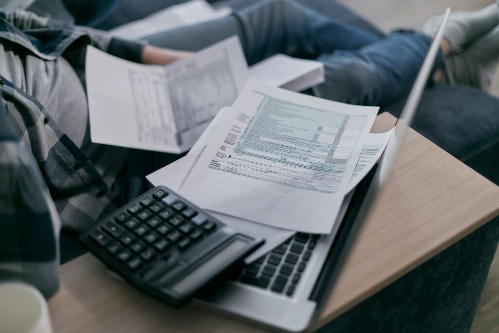 A person completing paperwork at a table—illustrating the documentation required to claim the Foreign Tax Credit and ensure IRS compliance for expats in 2025.