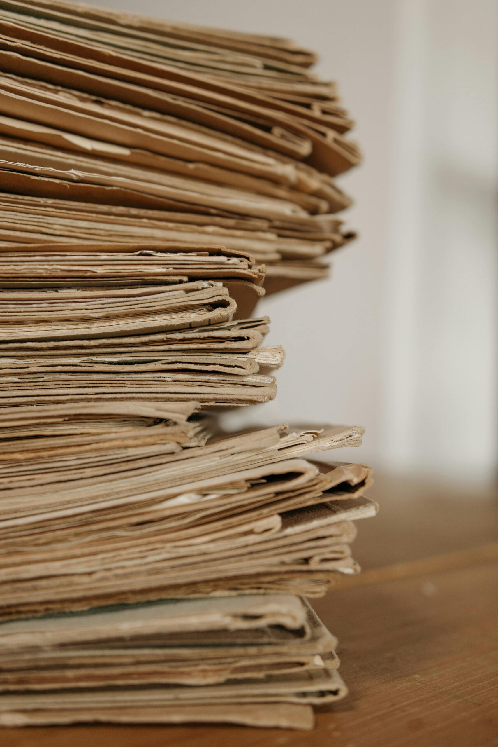 A desk covered with tax forms and economic forecasts reflects the rapid policy shifts of August 15, 2025. This week’s roundup includes IRS turnover, domestic R&D hiring boosts, and early winners and losers from the OB3 tax law.
