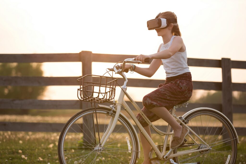 A woman wearing a VR headset pedals a stationary bike—reflecting how AI innovation may stall as startups navigate a fragmented state-by-state regulatory environment under the OBBB.