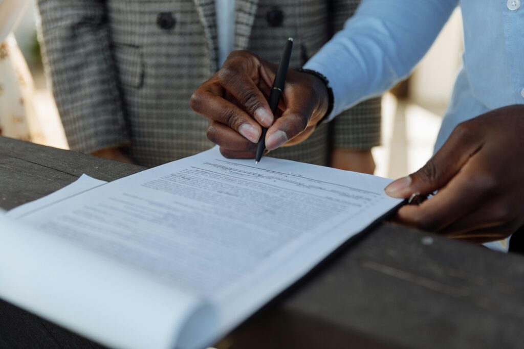 Image of a person signing a document.