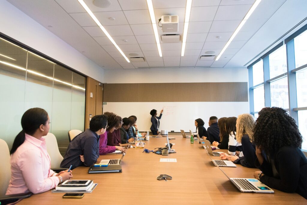 Image of a group of people in a conference room.