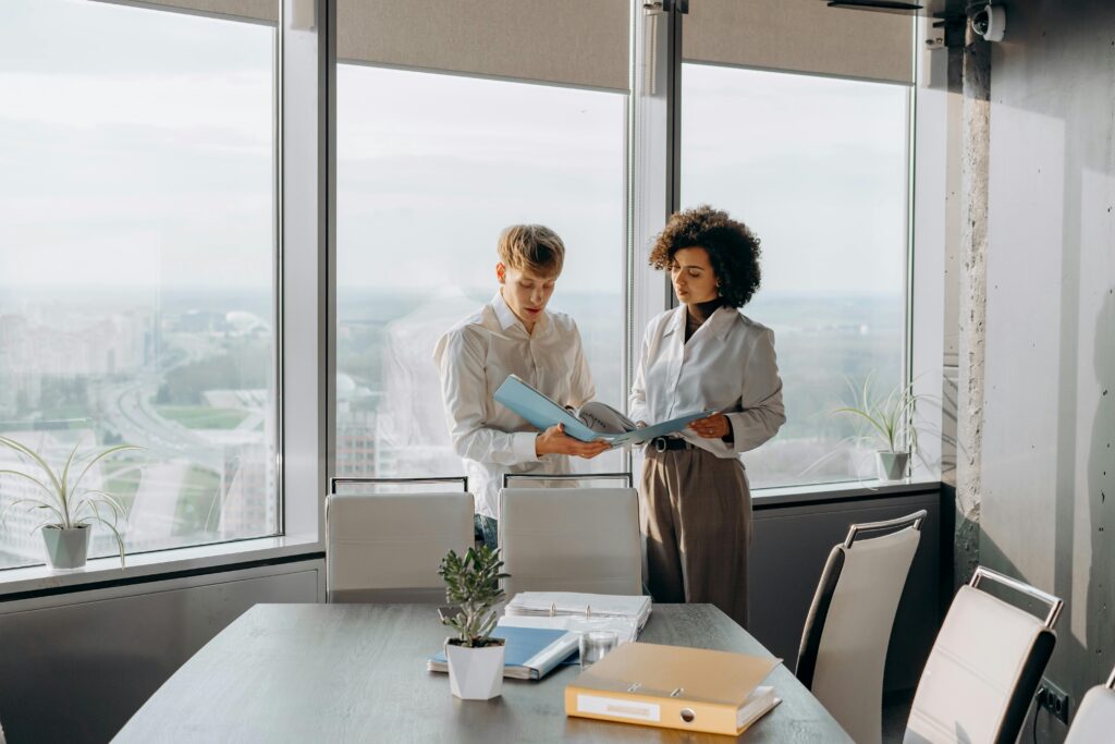 A man and woman analyze documents together at a desk, representing the collaborative tax planning and analysis required to implement advanced wealth transfer strategies like community property step-ups or alternate valuation dates.