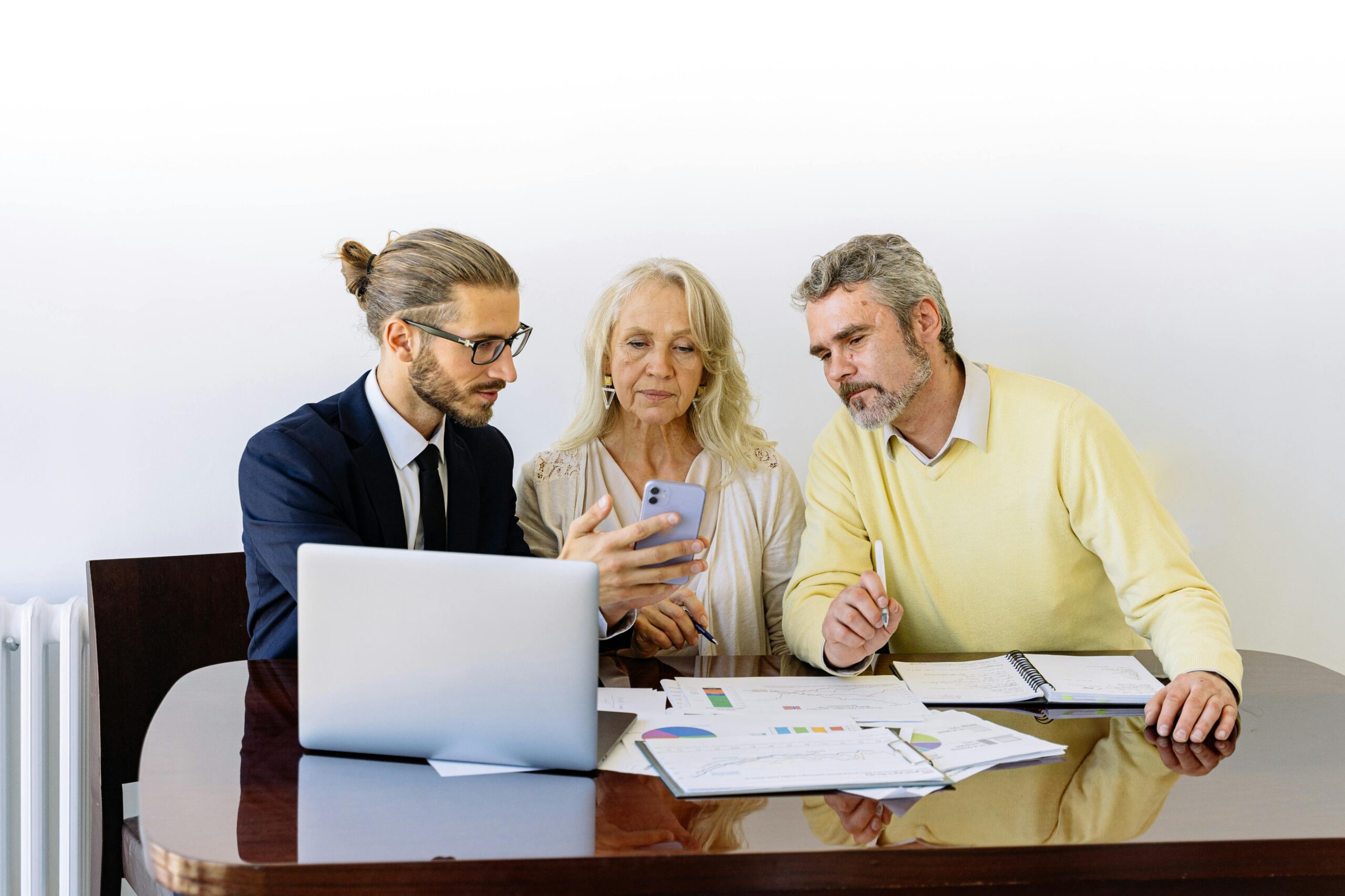A group of professionals seated at a table, reviewing documents together—representing the collaborative planning often involved in setting up an Intentionally Defective Grantor Trust (IDGT) for strategic wealth transfer.