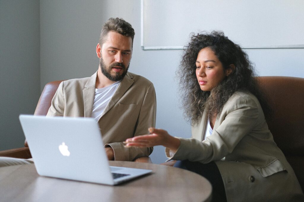 A focused team of professionals reviewing paperwork in an office setting—representing the collaborative tax and legal guidance needed to navigate buy-sell agreement funding complexities.