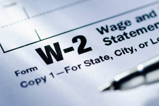 Close-up of a W-2 tax form with a pen resting on it—illustrating the importance of reviewing Box 12 codes for accurate income reporting and tax planning.