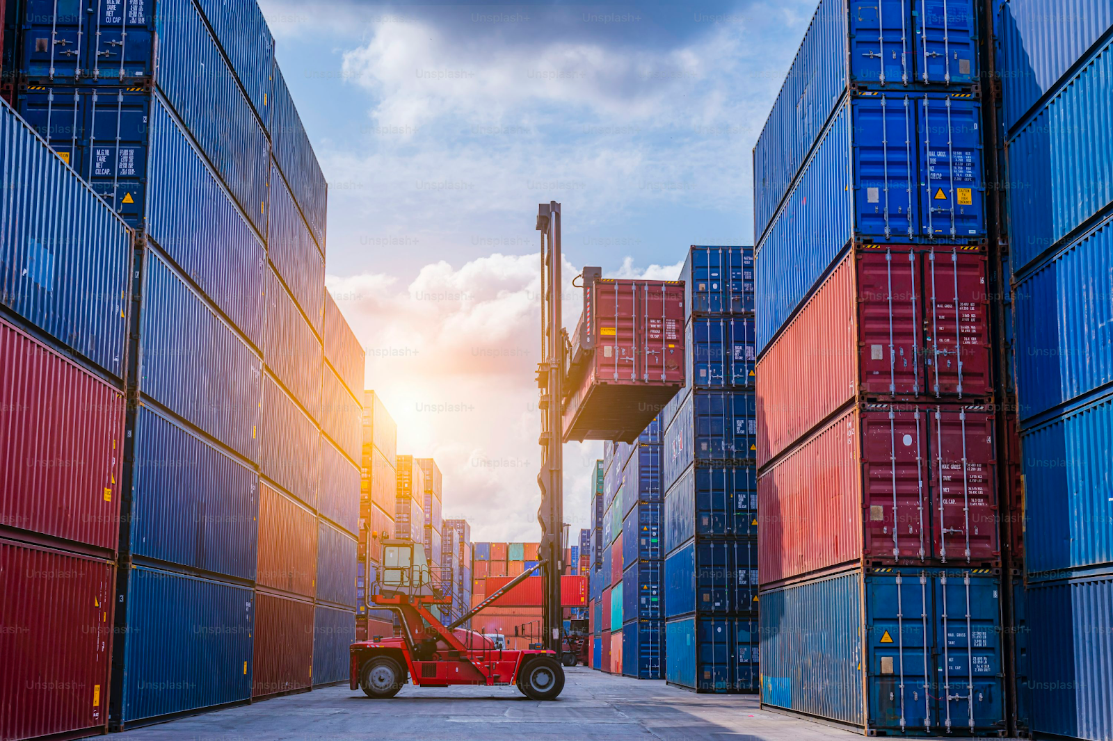 Forklift loading colorful shipping containers onto a cargo truck in a bustling port, symbolizing global logistics, international trade, and tariff-driven supply chain shifts.