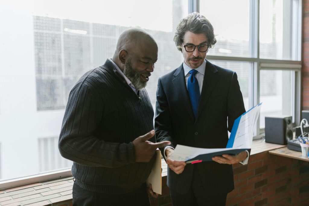 Business professionals reviewing tax planning documents for high-income charitable donors.